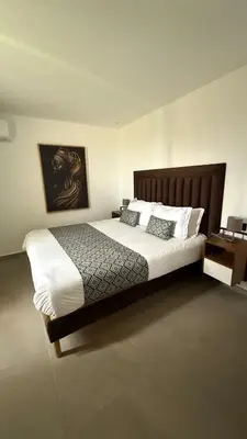 a bedroom with a large bed with white sheets and pillows at Exceptional Villa Noria Golf in Marrakech
