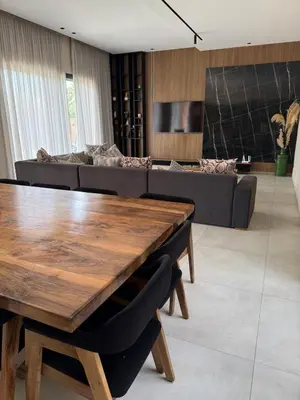 a living room with a wooden table and a couch at Luxury villa Noria golf club in Marrakech