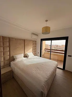a bedroom with a large bed with a large window at Appartement moderne confortable 2 chambres près de Marrakech Gueliz piscine in Marrakech