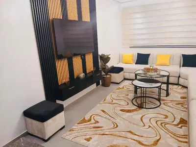 a living room with a couch and a table at Appartement Cozy Hivernage in Marrakech