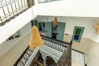 a staircase with two hanging hammocks in a house at Riad Qarya Petit-déjeuner et transfert inclus in Marrakech