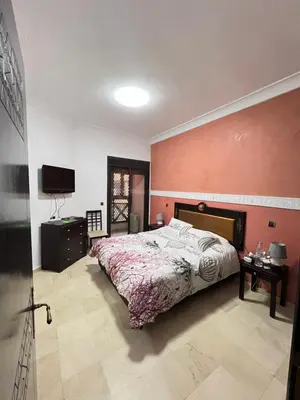 a bedroom with a bed and a flat screen tv at Quite place for your vacation in Marrakech