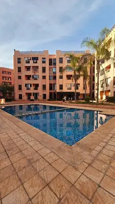 a large swimming pool in front of a building at Quite place for your vacation in Marrakech