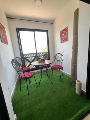 a room with a table and chairs and a window at Quite place for your vacation in Marrakech