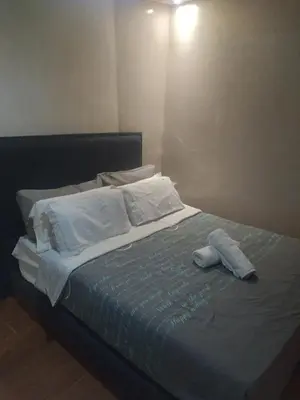 a bed with white sheets and pillows on it at chambre Economic Gueliz in Marrakech