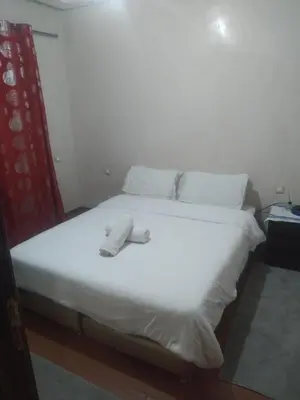 a white bed with white sheets and pillows on it at chambre Economic Gueliz in Marrakech