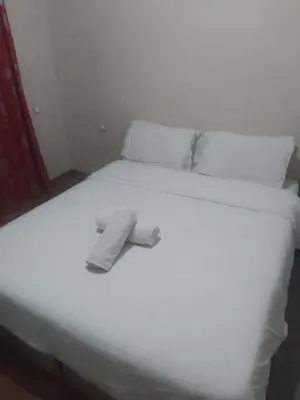 a white bed with white sheets and pillows at chambre Economic Gueliz in Marrakech