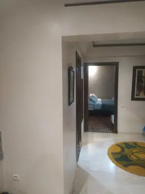 a hallway with a room with a bed and a mirror at chambre Economic Gueliz in Marrakech