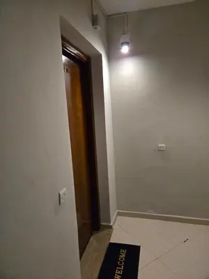 an empty hallway with a door and a light at Quiet and comfortable apartment in Marrakech
