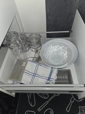 a drawer with a plate and a bowl and dishes at Quiet and comfortable apartment in Marrakech