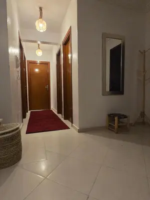 a hallway with a door and a red rug at Quiet and comfortable apartment in Marrakech