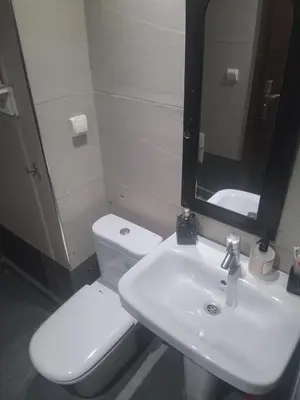 a bathroom with a sink and a toilet and a mirror at chambre Economic Gueliz in Marrakech