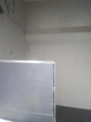 a room with a white wall and a glass container at chambre Economic Gueliz in Marrakech