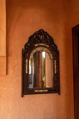 an ornate mirror on a wall in a room at la roseraie Marrakech in Marrakech