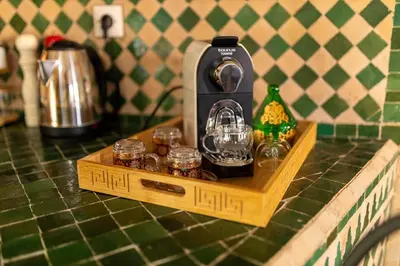 a coffee maker on a wooden tray on a counter at la roseraie Marrakech in Marrakech