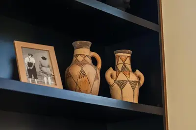 three vases sitting on a shelf with pictures at Oasis Privée - Dar Lola in Marrakech
