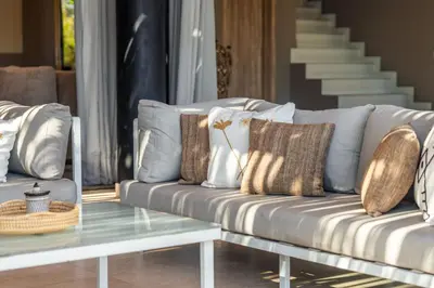 a white couch with pillows and a glass table at Oasis Privée - Dar Lola in Marrakech