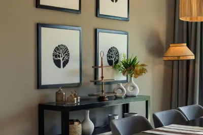 a living room with a table with three pictures on the wall at Oasis Privée - Dar Lola in Marrakech