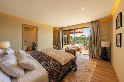 a bedroom with a bed and a large window at Oasis Privée - Dar Lola in Marrakech
