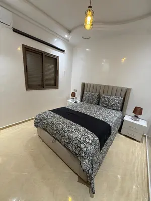 a bedroom with a large bed in a white room at KSYI IMMO 4 Marrakech Aéroport in Marrakech