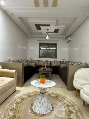 a living room with a couch and a table at KSYI IMMO 4 Marrakech Aéroport in Marrakech