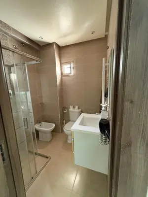 a bathroom with a toilet and a sink and a shower at KSYI IMMO 4 Marrakech Aéroport in Marrakech