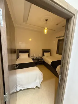 a hotel room with two beds and a doorway at KSYI IMMO 4 Marrakech Aéroport in Marrakech