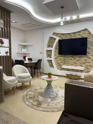 a living room with a tv on a brick wall at KSYI IMMO 4 Marrakech Aéroport in Marrakech