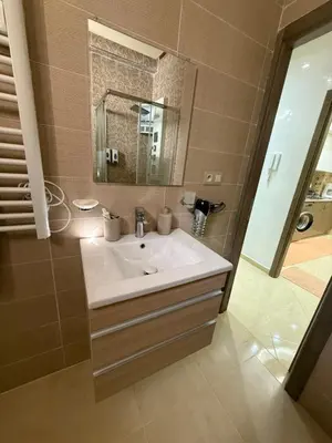 a bathroom with a sink and a mirror at KSYI IMMO 4 Marrakech Aéroport in Marrakech