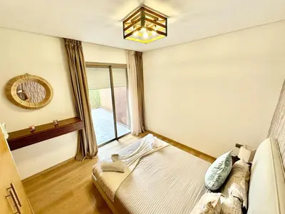 a bedroom with a bed and a window at Comfy Luxe Stay Golf View Marrakech in Marrakech