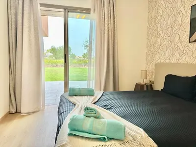 a bedroom with a bed with two towels on it at Comfy Luxe Stay Golf View Marrakech in Marrakech