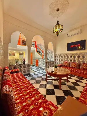 a living room with a couch and a table at Riad Authentique à quelques pas de Jamaa El-Fna in Marrakech
