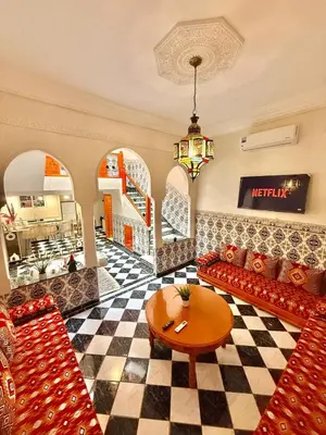 a living room with a couch and a table at Riad Authentique à quelques pas de Jamaa El-Fna in Marrakech