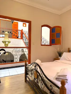 a bedroom with a bed and a view of a balcony at Riad Authentique à quelques pas de Jamaa El-Fna in Marrakech