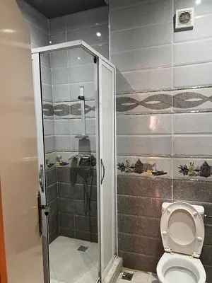 a bathroom with a shower and a toilet at Modern Apartment 5 Min from Airport & Secure in Marrakech