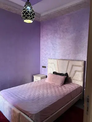 a bedroom with purple walls and a large bed at Modern Apartment 5 Min from Airport & Secure in Marrakech