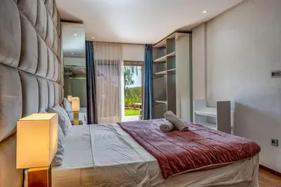 a bedroom with a large bed in a room at Prestigia Agate Appartement luxueux Marrakech golf city in Marrakech