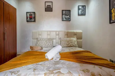 a bedroom with a large bed with towels on it at Prestigia Agate Appartement luxueux Marrakech golf city in Marrakech
