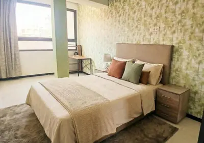 a bedroom with a large bed and a window at Appart zénith in Marrakech