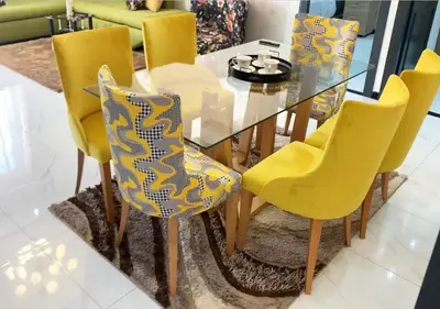 a dining room table and chairs with yellow chairs at Appart zénith in Marrakech
