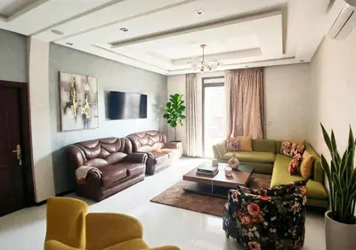 a living room with a couch and a table at Appart zénith in Marrakech
