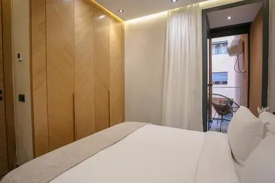 a bedroom with a large white bed and a window at A Spot With No Rush - Marrakech in Marrakech