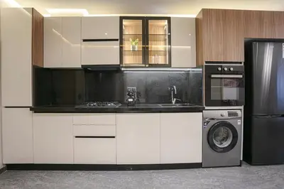 a kitchen with white cabinets and a washer and dryer at A Spot With No Rush - Marrakech in Marrakech