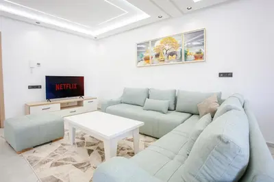 a living room with a couch and a tv at Good Vibes - Hivernage Marrakech in Marrakech