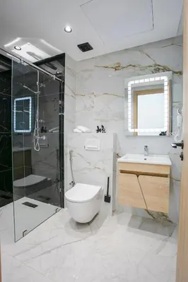 a bathroom with a toilet and a shower and a sink at Good Vibes - Hivernage Marrakech in Marrakech