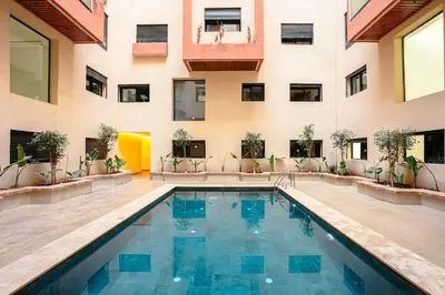 a swimming pool in the middle of a building at Good Vibes - Hivernage Marrakech in Marrakech