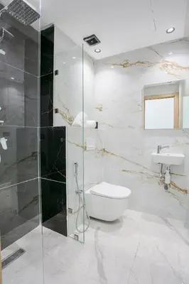 a bathroom with a shower and a toilet and a sink at The Right Address - Hivernage Marrakech in Marrakech