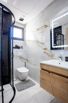 a bathroom with a toilet and a sink and a shower at The Cozy Corner - Hivernage Marrakech in Marrakech