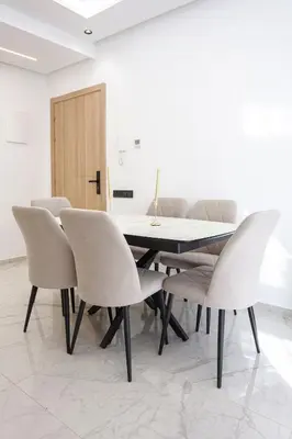 a dining room with a table and chairs at The Cozy Corner - Hivernage Marrakech in Marrakech