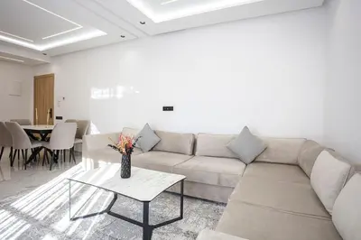 a living room with a couch and a table at The Cozy Corner - Hivernage Marrakech in Marrakech